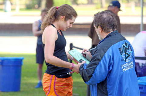 Volunteer helping at a 5k event.