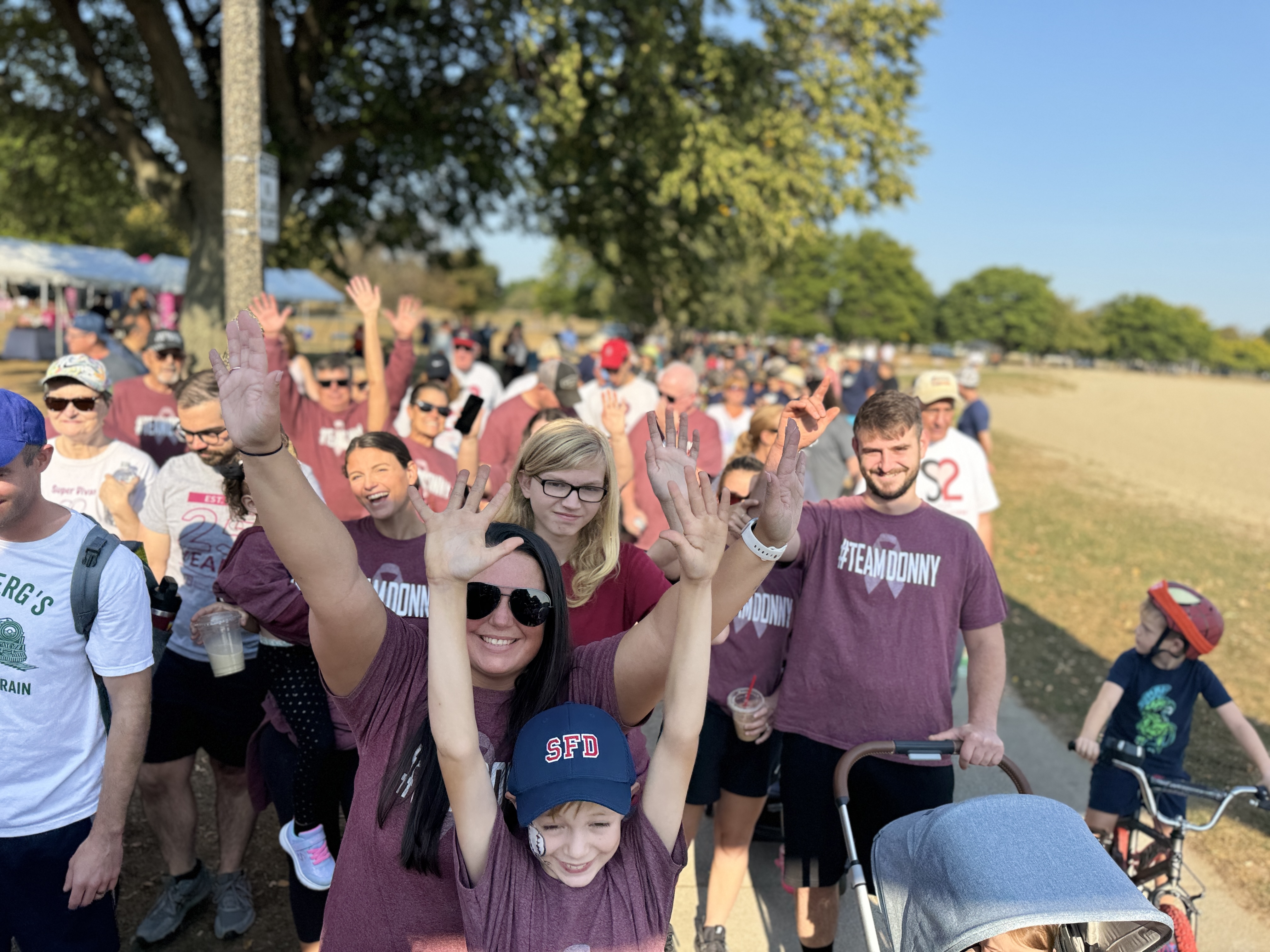 A crowd of people on a walk.