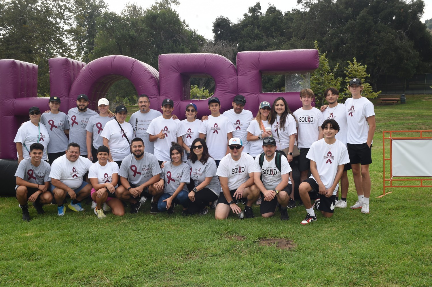 Carlos and a group in front of a hope sign.