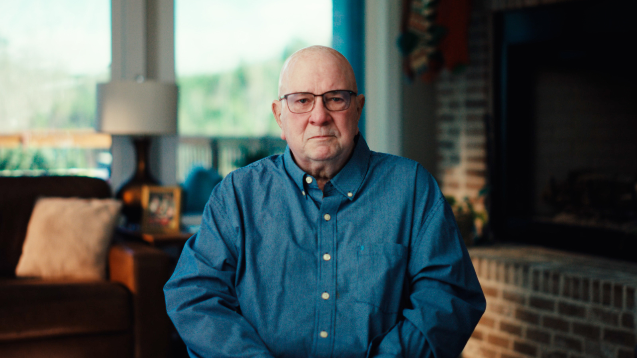 Myeloma patient Randy wears a blue shirt and looks directly at the camera during a video interview